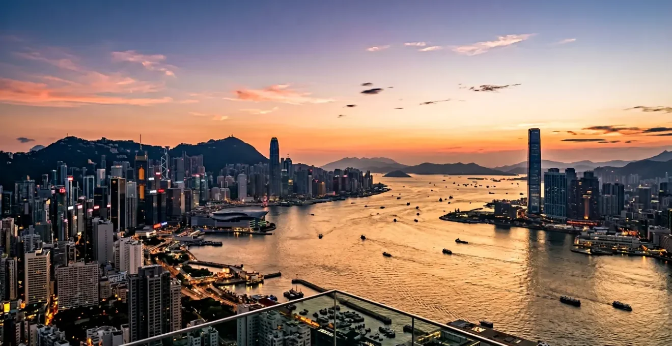Panoramic view of Victoria Harbour skyline from an elevated observation deck at golden hour