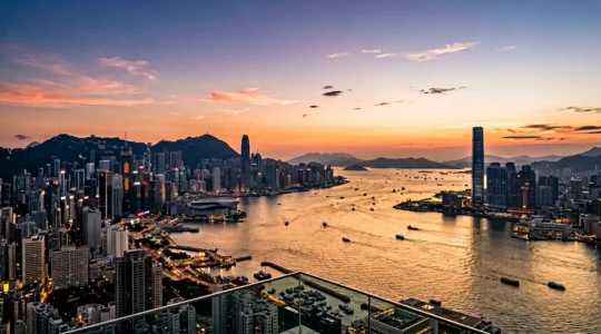 Panoramic view of Victoria Harbour skyline from an elevated observation deck at golden hour