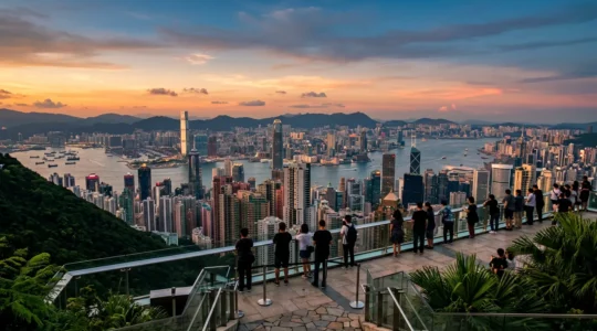 Panoramic view of Hong Kong skyline from Victoria Peak during golden hour with harbor and skyscrapers
