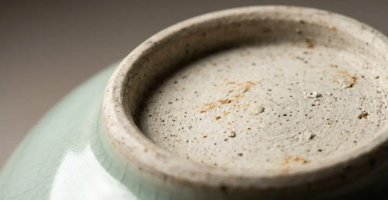 Extreme close-up of authentic antique porcelain foot-rim showing natural aging patterns