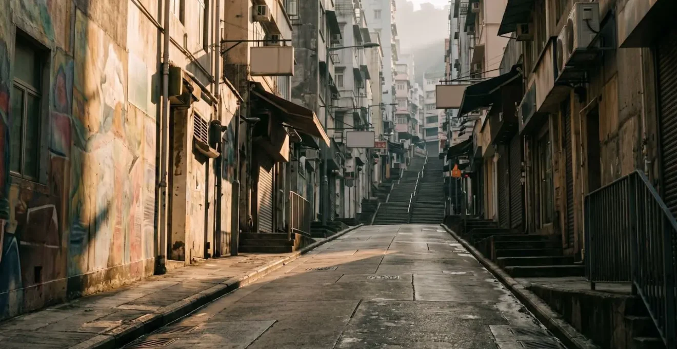 Early morning golden light illuminating empty Sheung Wan street with murals