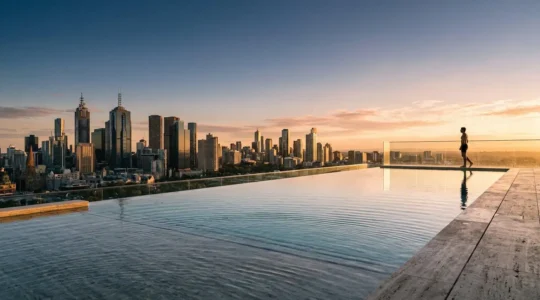 Luxury infinity pool overlooking city skyline at golden hour