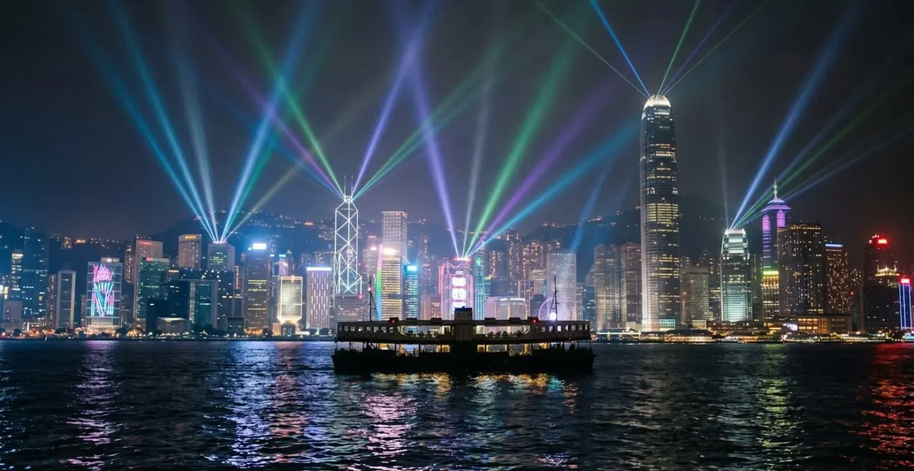 Star Ferry positioned in Victoria Harbour during Symphony of Lights show with laser beams