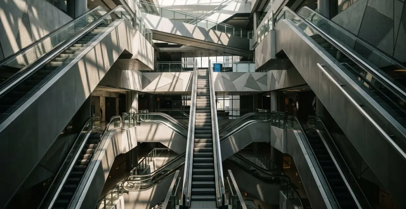 Interior view of a multi-level shopping mall with interconnected escalators and open atrium spaces